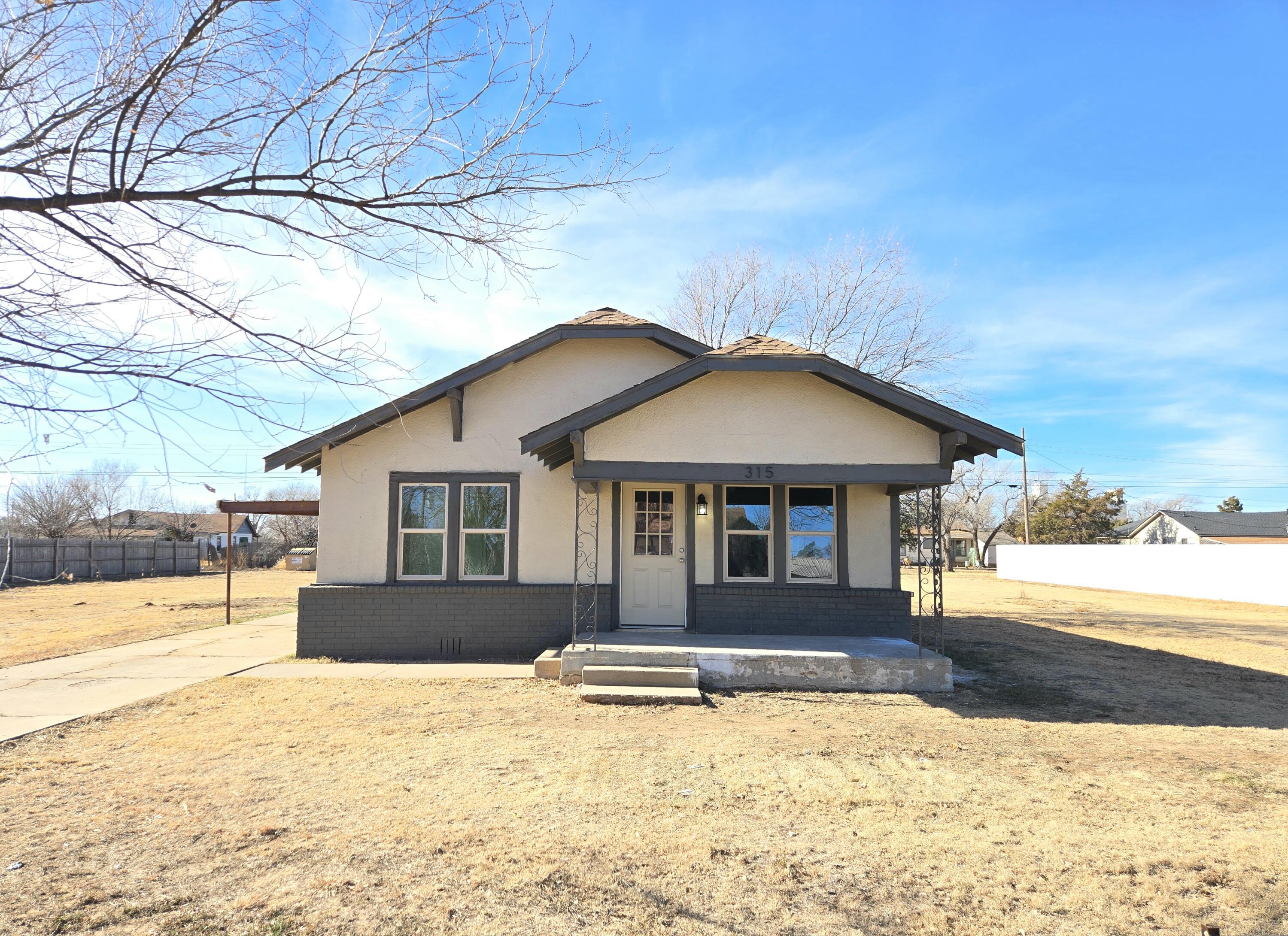 315 North Floyd Avenue Tulia, TX 79088 - Photo 1 of 24 a front view of a house with a yard