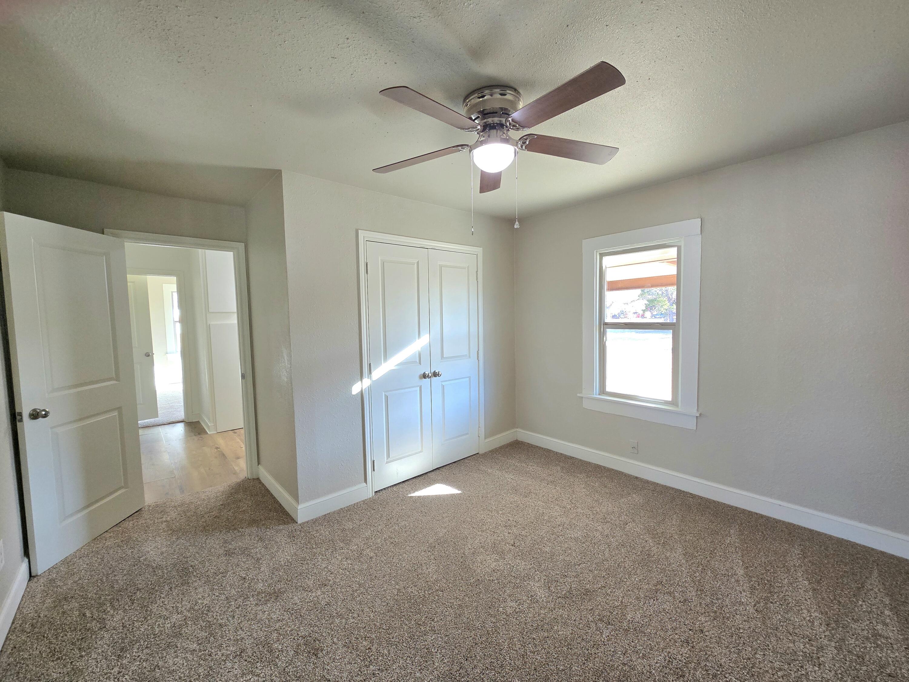 315 North Floyd Avenue Tulia, TX 79088 - Photo 12 of 24 an empty room with fan and windows