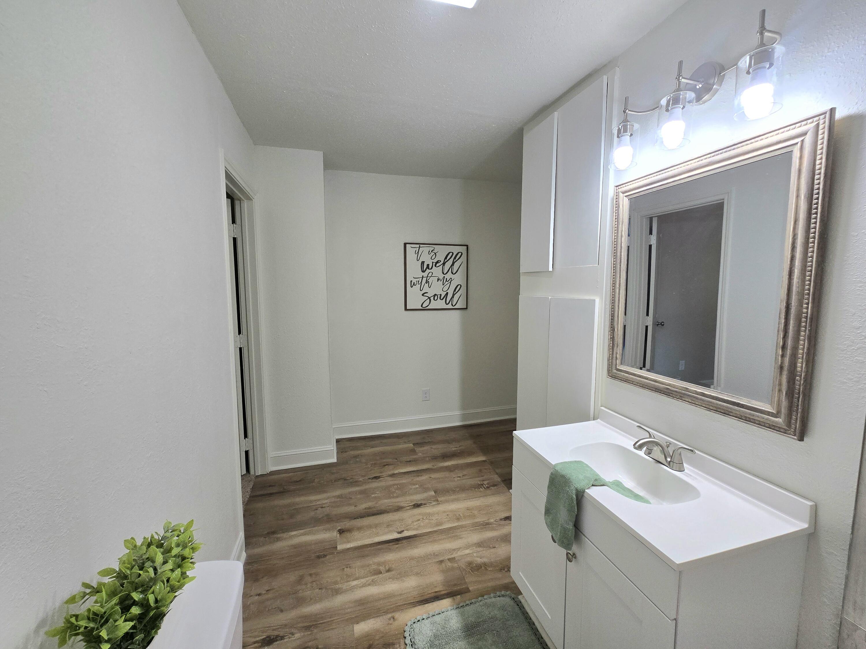 315 North Floyd Avenue Tulia, TX 79088 - Photo 15 of 24 a bathroom with a sink and a mirror