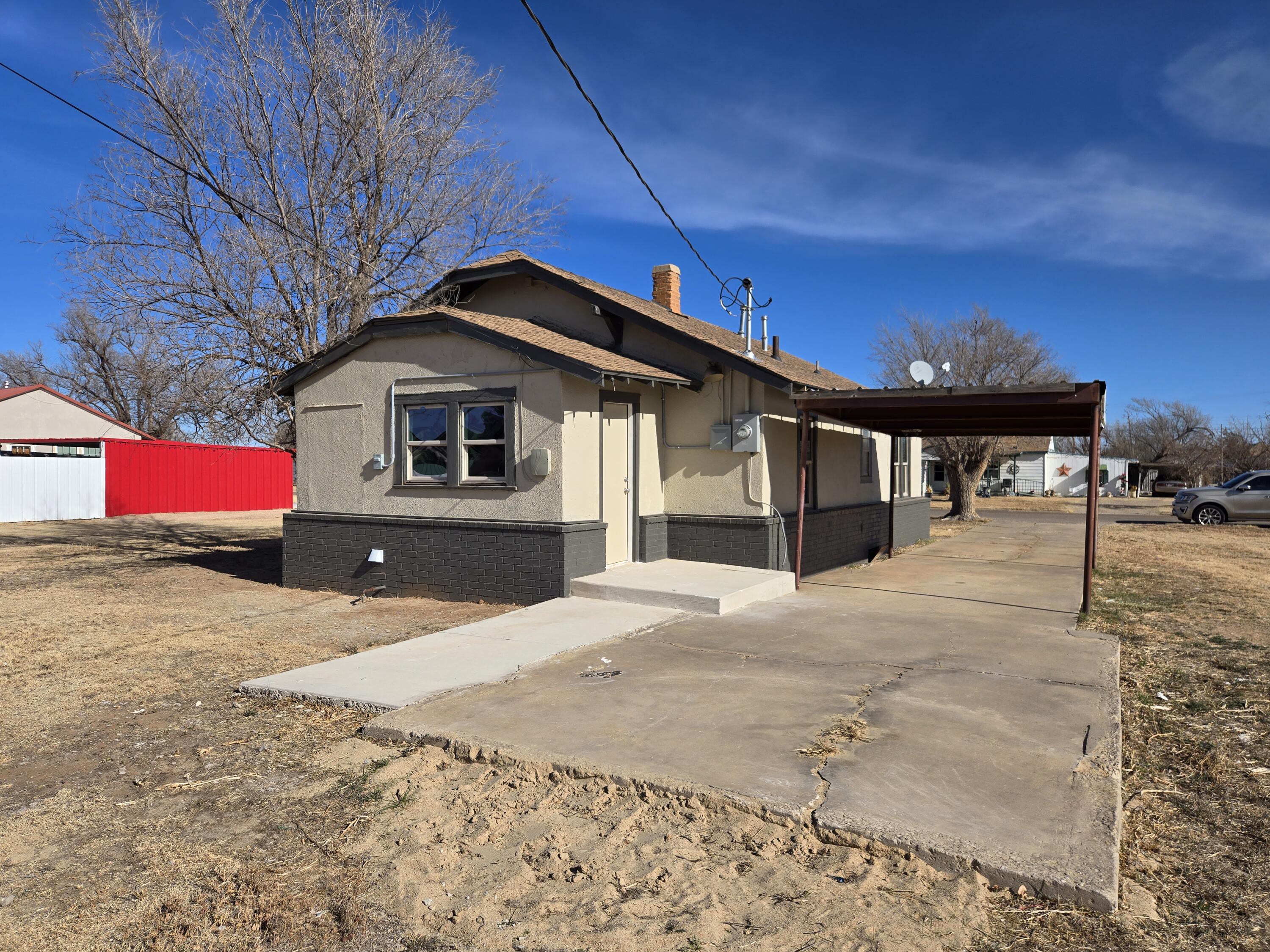 315 North Floyd Avenue Tulia, TX 79088 - Photo 21 of 24 a front view of a house with a yard