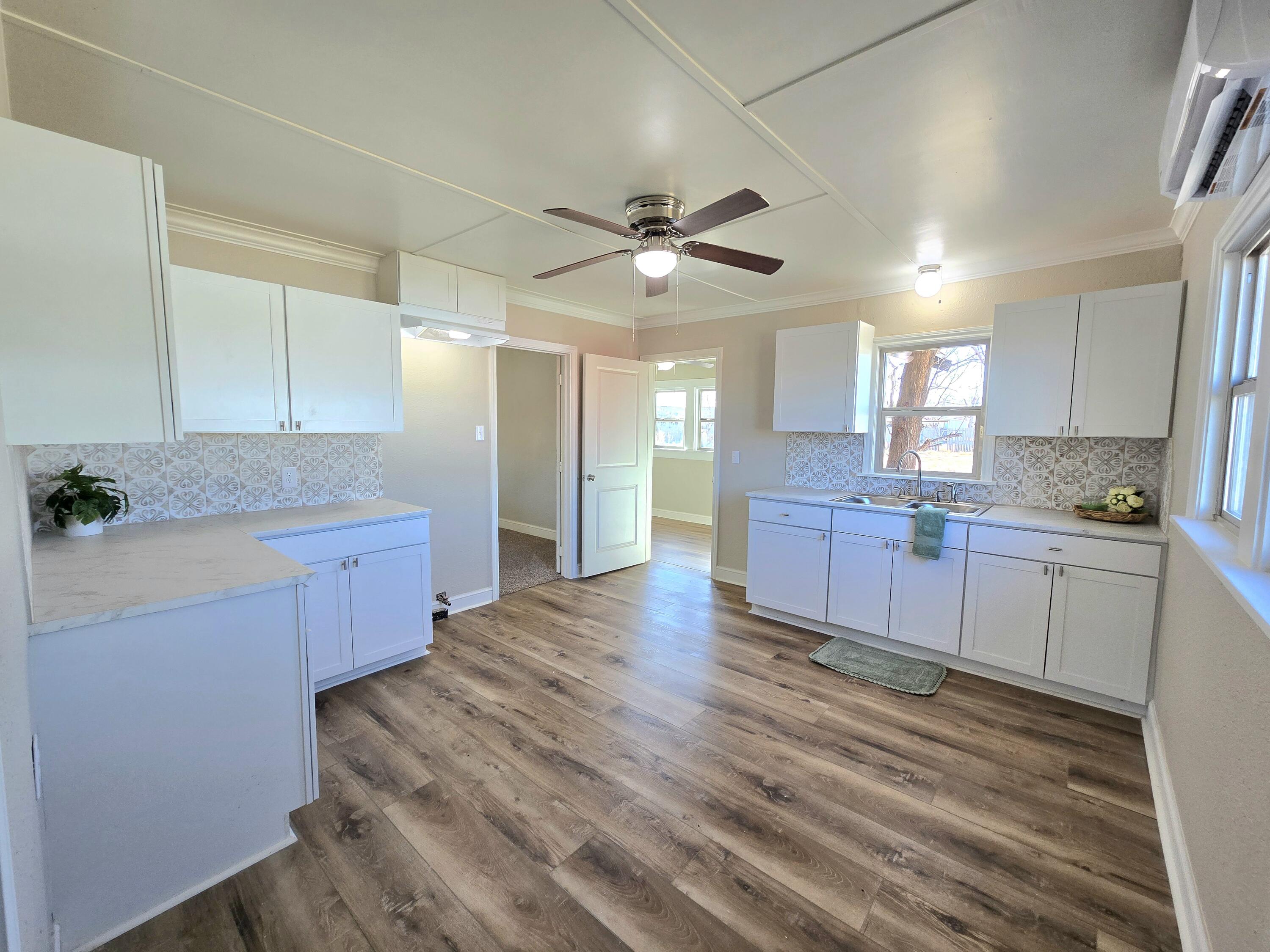 315 North Floyd Avenue Tulia, TX 79088 - Photo 8 of 24 a kitchen with stainless steel appliances kitchen island granite countertop a stove a sink and a refrigerator