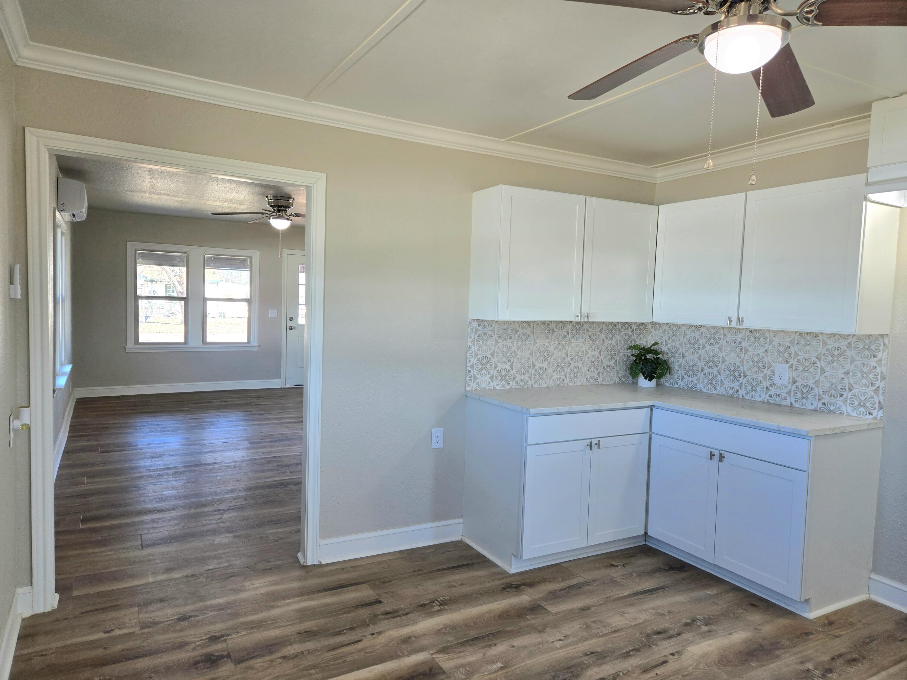 315 North Floyd Avenue Tulia, TX 79088 - Photo 9 of 24 a view of a kitchen cabinets and wooden floor