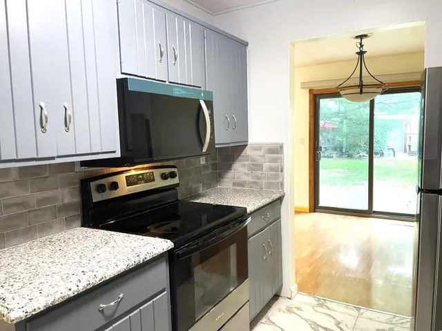 a kitchen with a stove and a microwave
