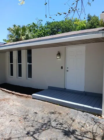 a view of a house with a wooden fence