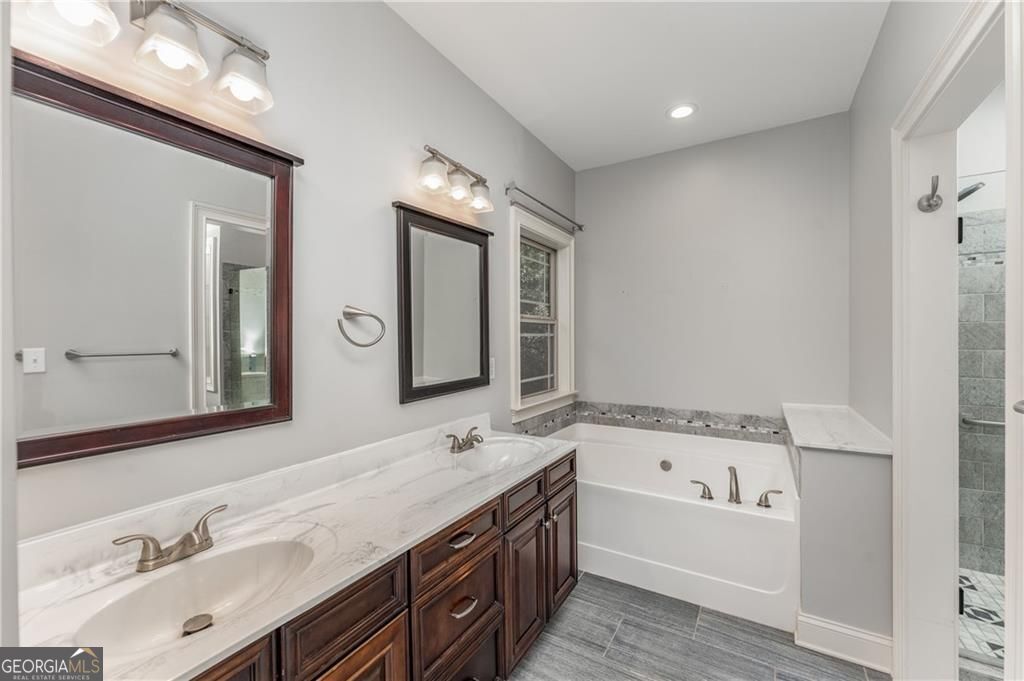 1158 Bailey Road Aragon, GA 30104 - Photo 25 of 73 a bathroom with a tub a double vanity sink and mirror