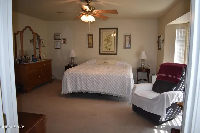 a bedroom with a bed couch and dresser