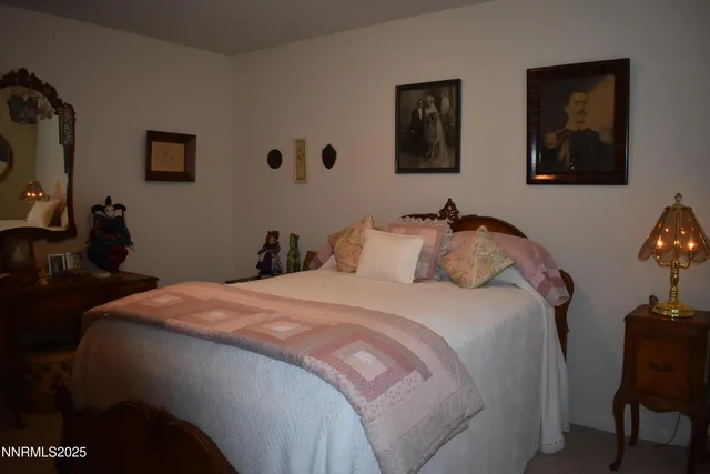 a bedroom with bed and wall painting