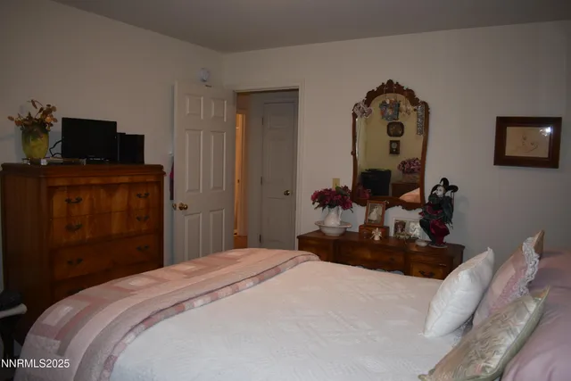 a bedroom with a bed and a television