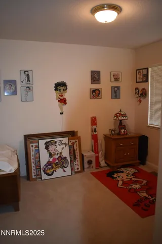 a living room with furniture and paintings on the wall