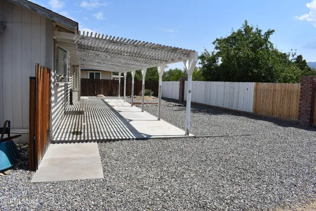 a view of a patio with wooden floor and fence