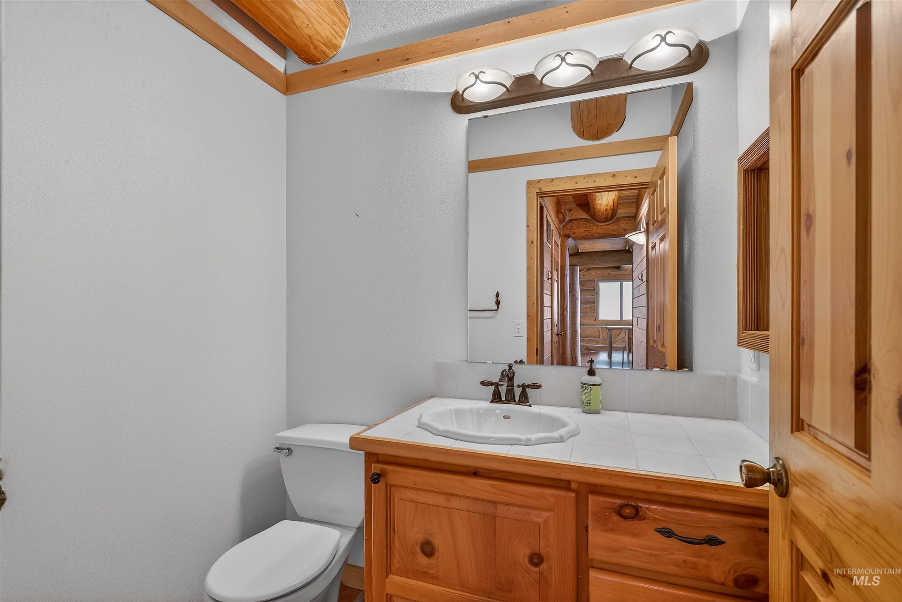 915 Doumecq Road White Bird, ID 83554 - Photo 26 of 49 Half bathroom featuring toilet and vanity
