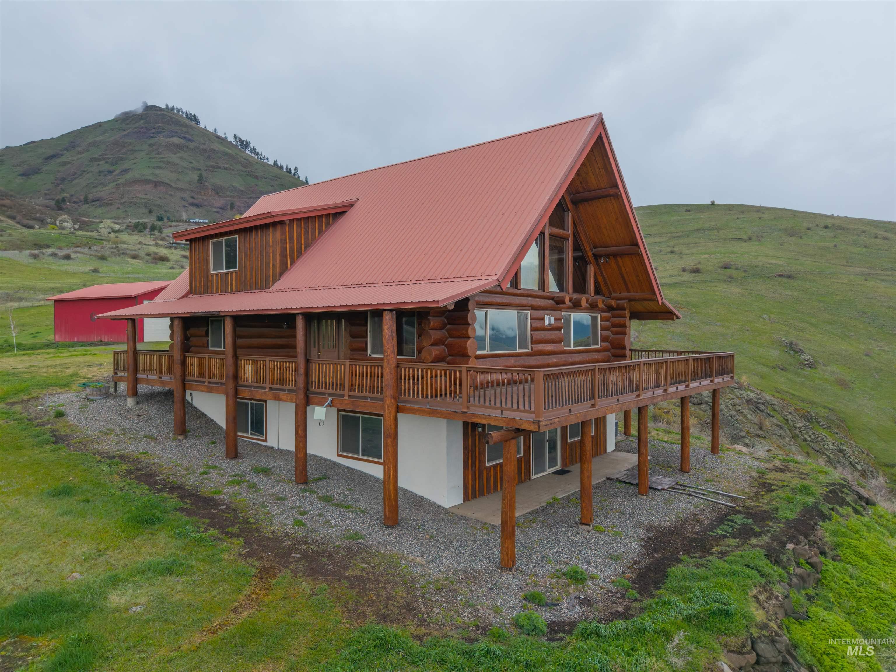 915 Doumecq Road White Bird, ID 83554 - Photo 4 of 49 Rear view of property with a metal roof, log siding, and a mountain view