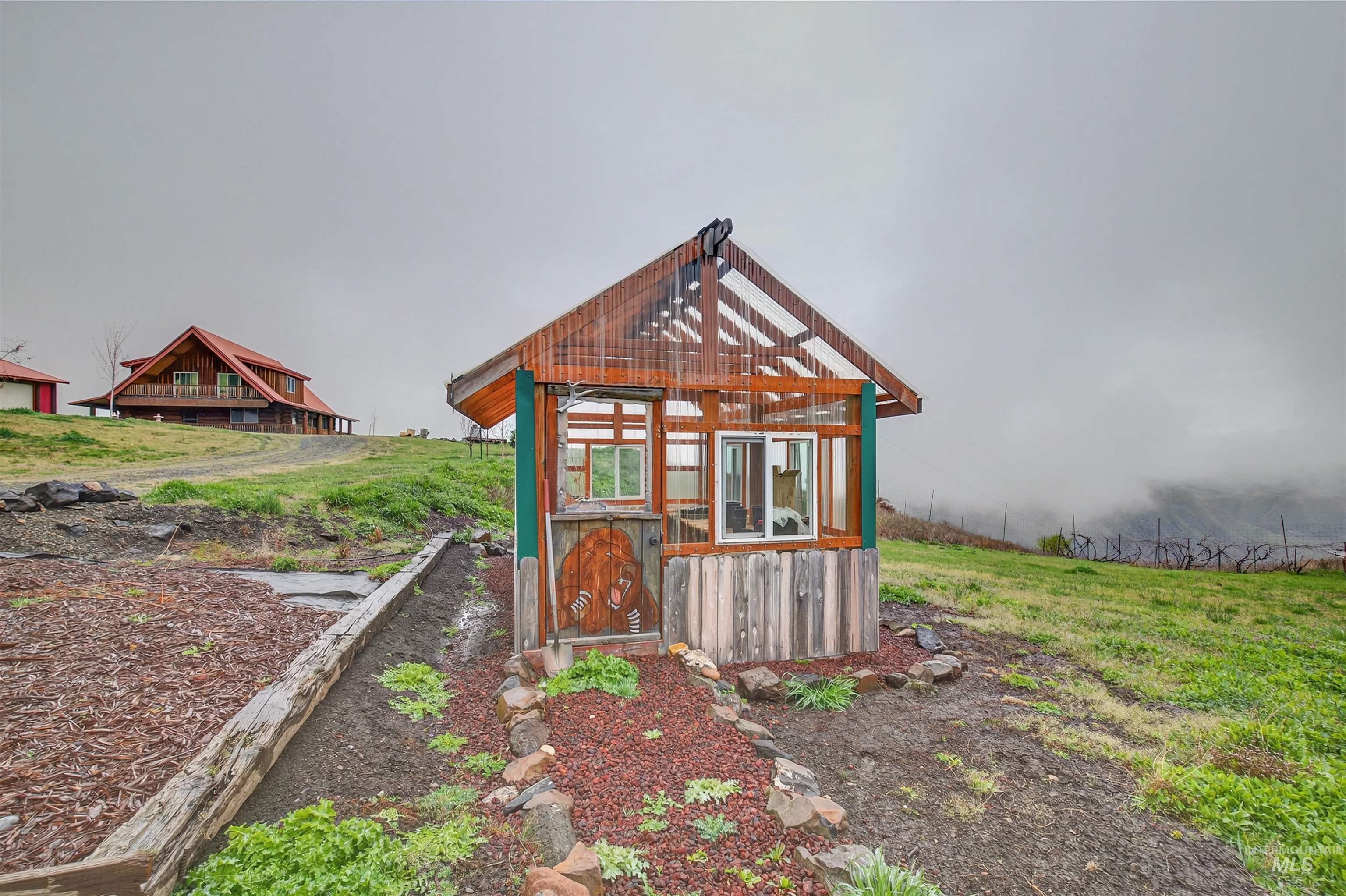 915 Doumecq Road White Bird, ID 83554 - Photo 47 of 49 View of greenhouse with a lawn