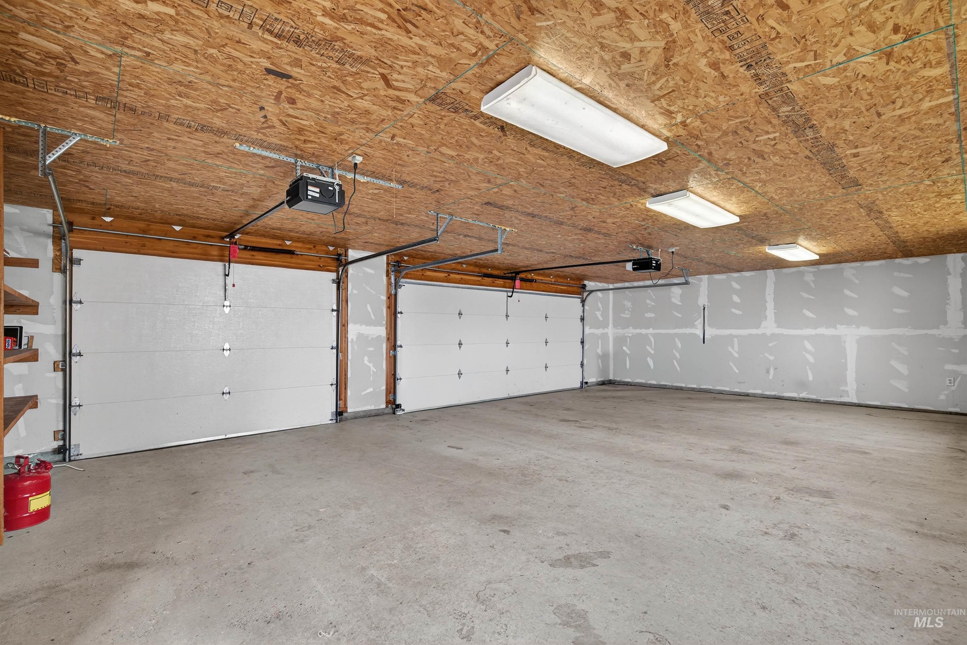915 Doumecq Road White Bird, ID 83554 - Photo 8 of 49 Garage featuring a garage door opener