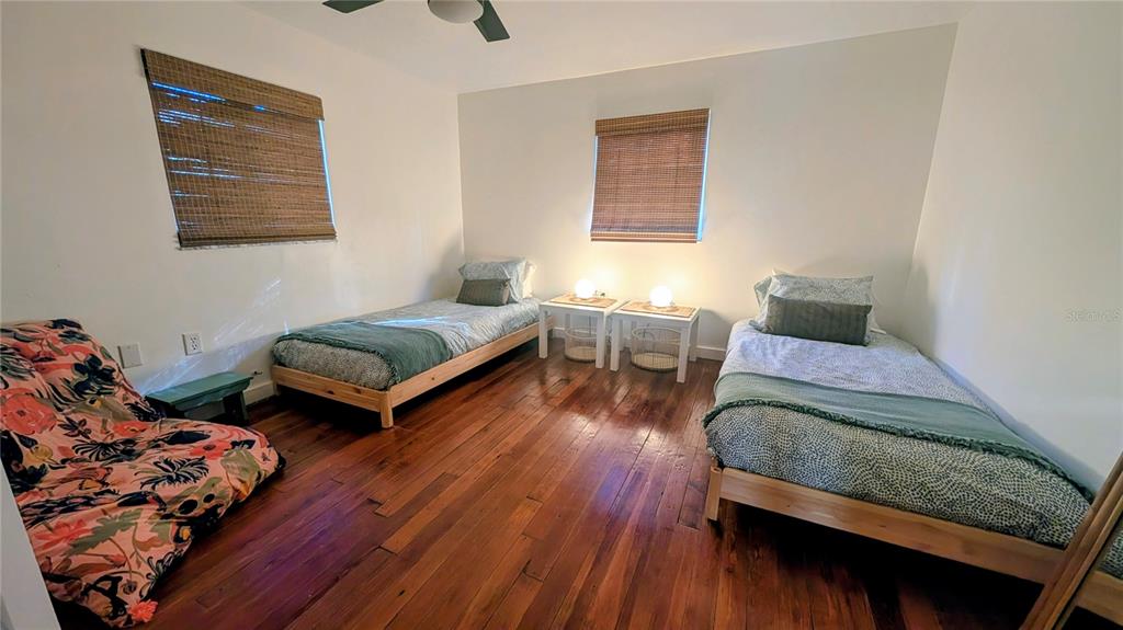 9350 Southeast 170th Avenue Road Ocklawaha, FL 32179 - Photo 23 of 69 a bedroom with two beds and wooden floor