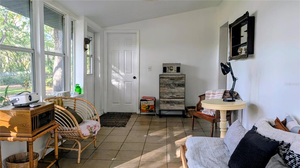 9350 Southeast 170th Avenue Road Ocklawaha, FL 32179 - Photo 4 of 69 a living room with furniture a wooden floor and a large window