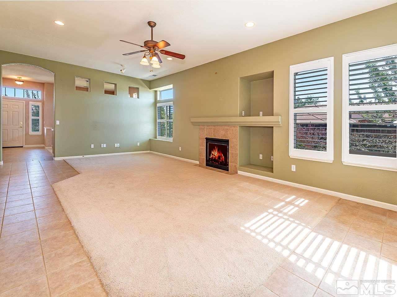 1790 Oxcart Court Reno, NV 89521 - Photo 9 of 20 a view of an empty room with a fireplace and a window