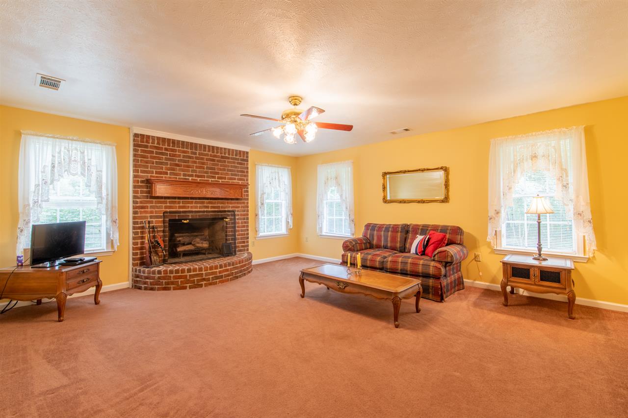 414 Simmons Road Munford, TN 38058 - Photo 6 of 24 Carpeted Den With Smooth Ceilings And Several Windows Let The Natural Light In.