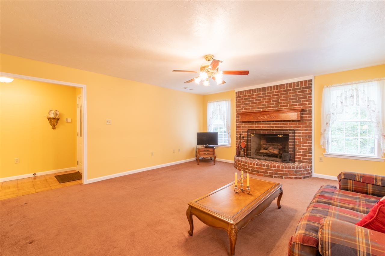414 Simmons Road Munford, TN 38058 - Photo 7 of 24 A Bricked Wood Fireplace With Step Up Hearth and Mantel Make For Cozy Seating