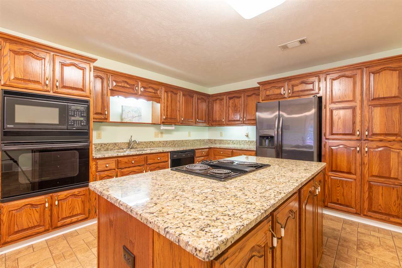 414 Simmons Road Munford, TN 38058 - Photo 8 of 24 Get Ready To Cook! There Are Too Many Cabinets To Count In This Kitchen. Brand New Granite, Drop In Cooktop, Undermount Sink, Built In Oven/Microwave.