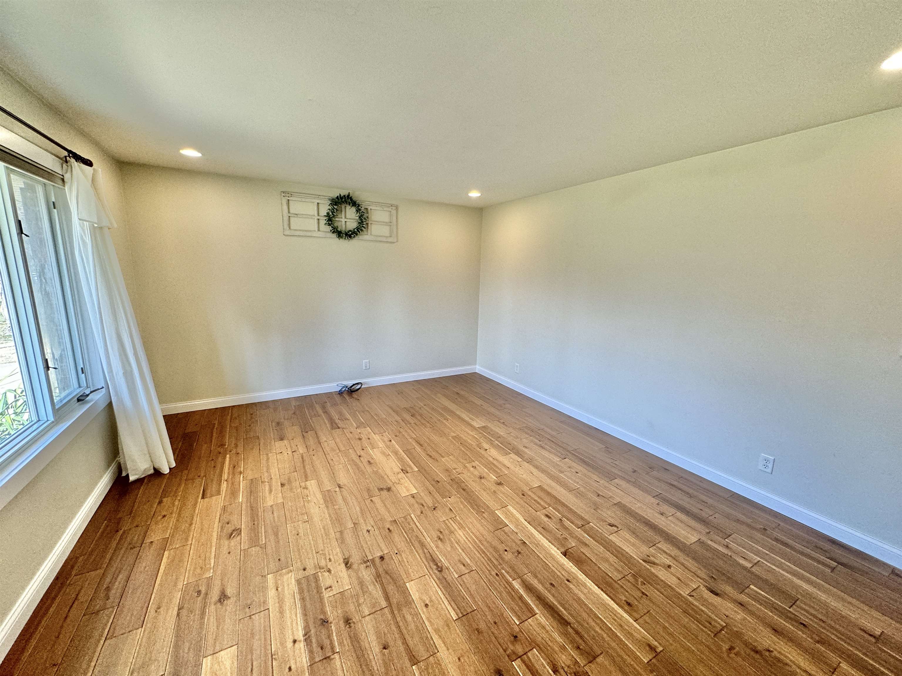 6694 Belvidere Road Roscoe, IL 61073 - Photo 11 of 32 a view of empty room with wooden floor and fan