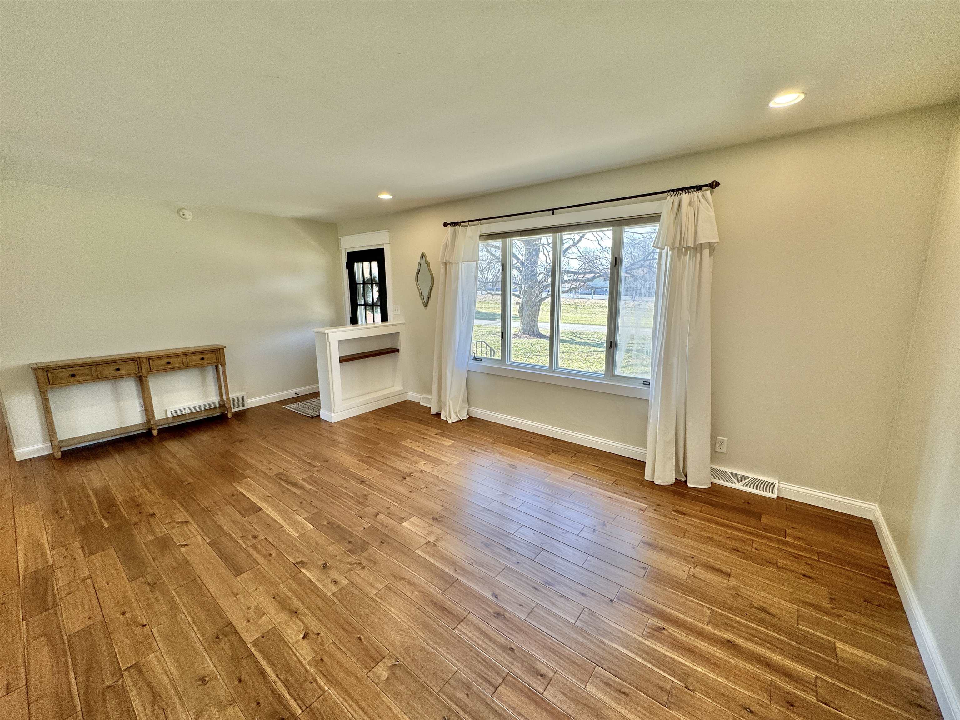 6694 Belvidere Road Roscoe, IL 61073 - Photo 13 of 32 a view of empty room with wooden floor and fan