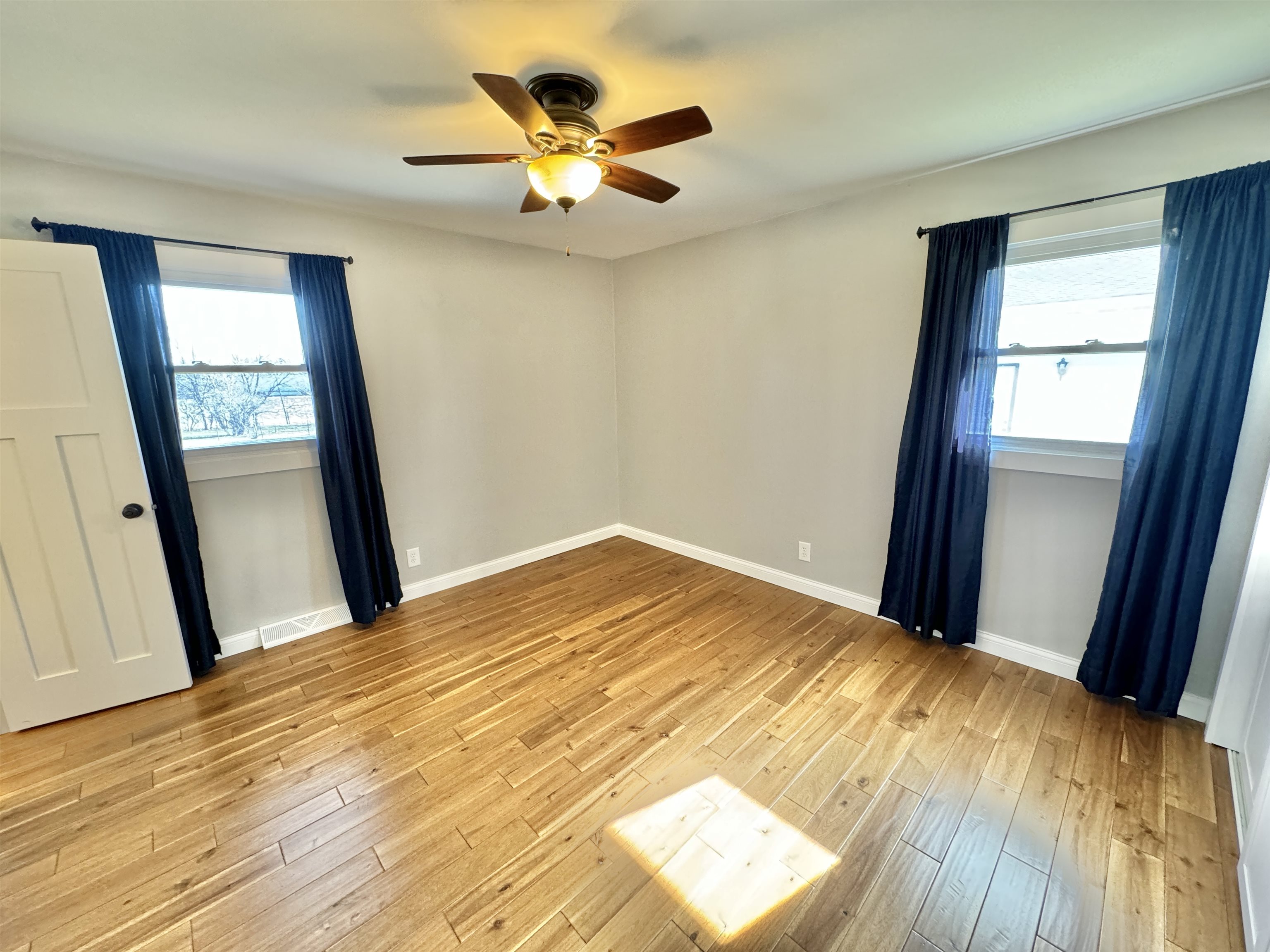 6694 Belvidere Road Roscoe, IL 61073 - Photo 19 of 32 a view of empty room with wooden floor and fan