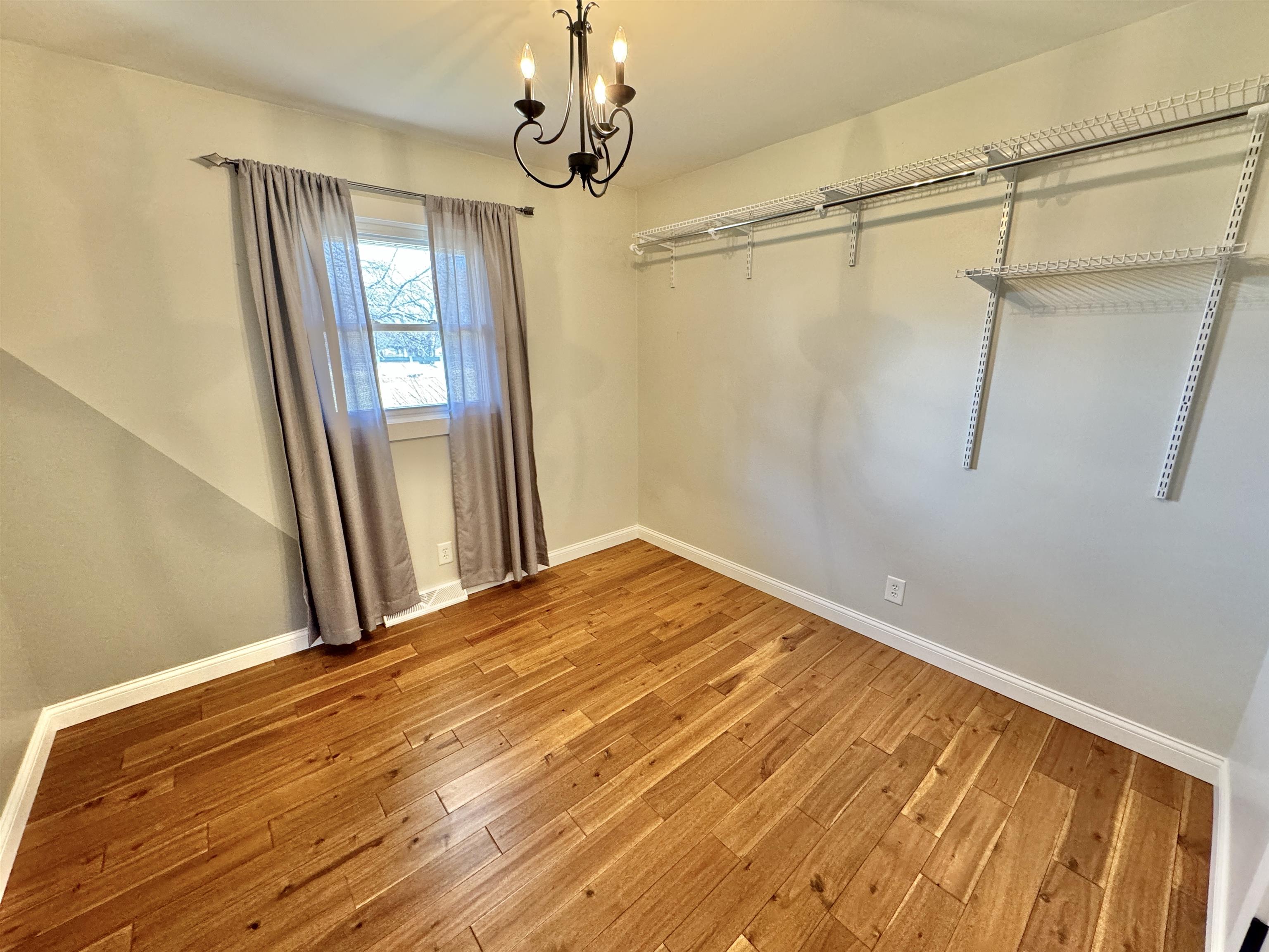 6694 Belvidere Road Roscoe, IL 61073 - Photo 25 of 32 a view of a room with wooden floor and windows