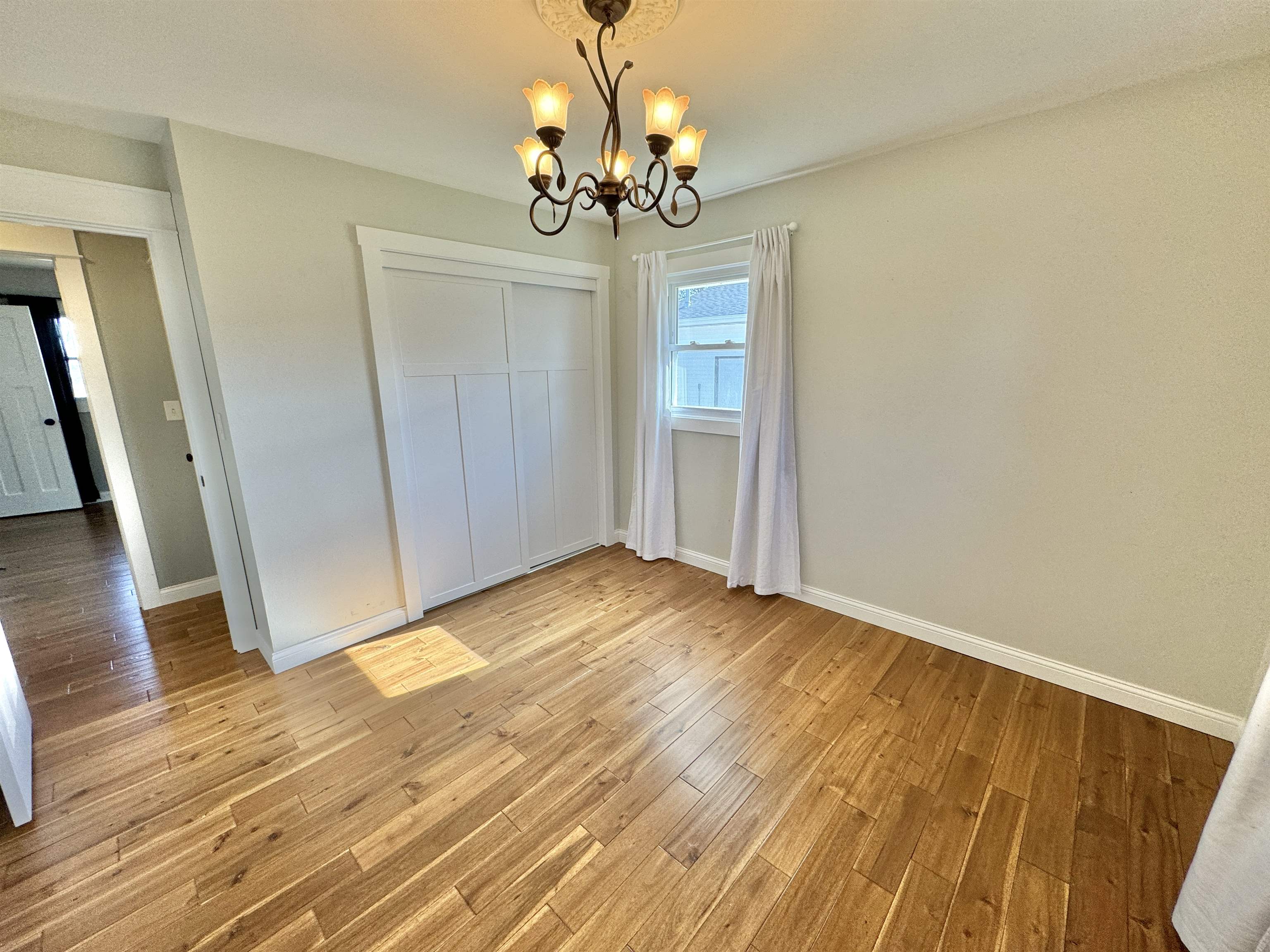 6694 Belvidere Road Roscoe, IL 61073 - Photo 28 of 32 a view of empty room with wooden floor and fan