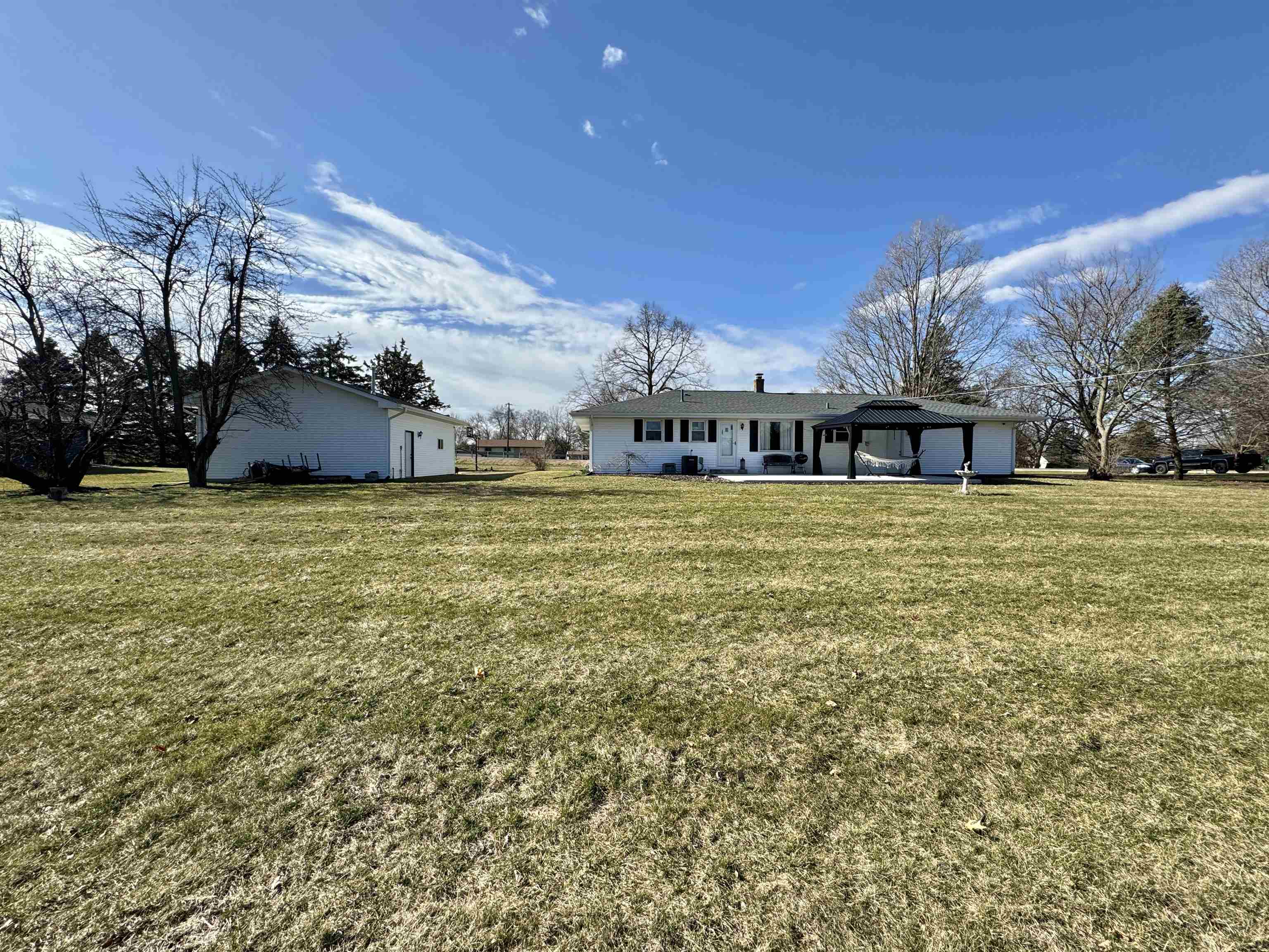 6694 Belvidere Road Roscoe, IL 61073 - Photo 6 of 32 a view of a large pool with lawn chairs under an umbrella