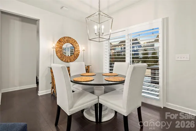 a view of a dining room with furniture wooden floor and a chandelier