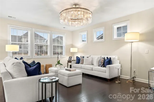 a living room with furniture and a chandelier