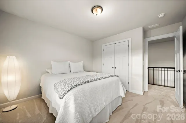 a living room with furniture and a large window with wooden floor
