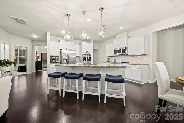 a large kitchen with a table and chairs
