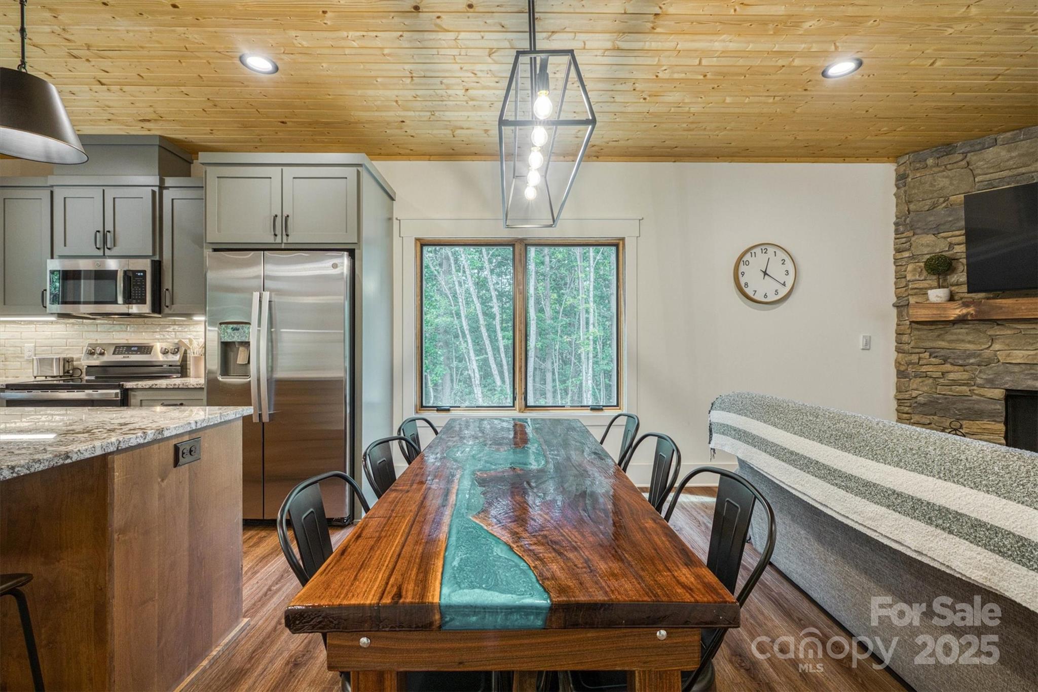 1370 Saylor Way, Unit 8 Nebo, NC 28761 - Photo 21 of 44 a kitchen with stainless steel appliances wooden cabinets a stove and a refrigerator
