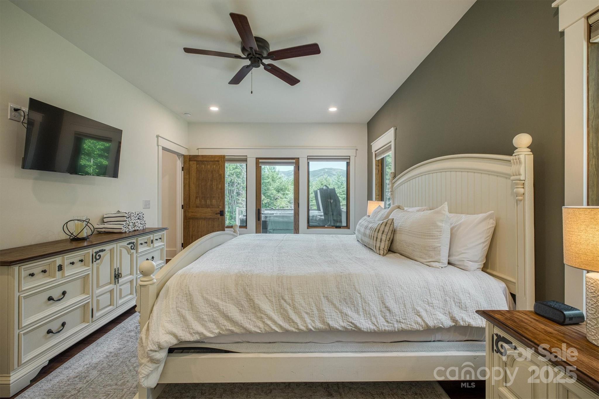 1370 Saylor Way, Unit 8 Nebo, NC 28761 - Photo 31 of 44 a bedroom with a large bed and a flat tv screen on dresser