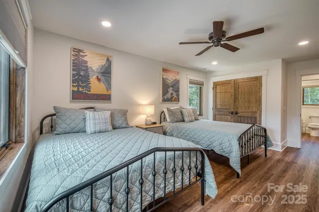 a bedroom with a bed and a large mirror