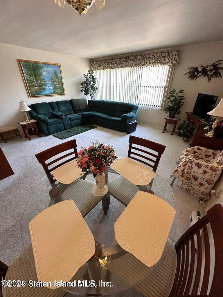 1000 Clove Road, Unit 3F Staten Island, NY 10301 - Photo 11 of 13 a living room with furniture and wooden floor