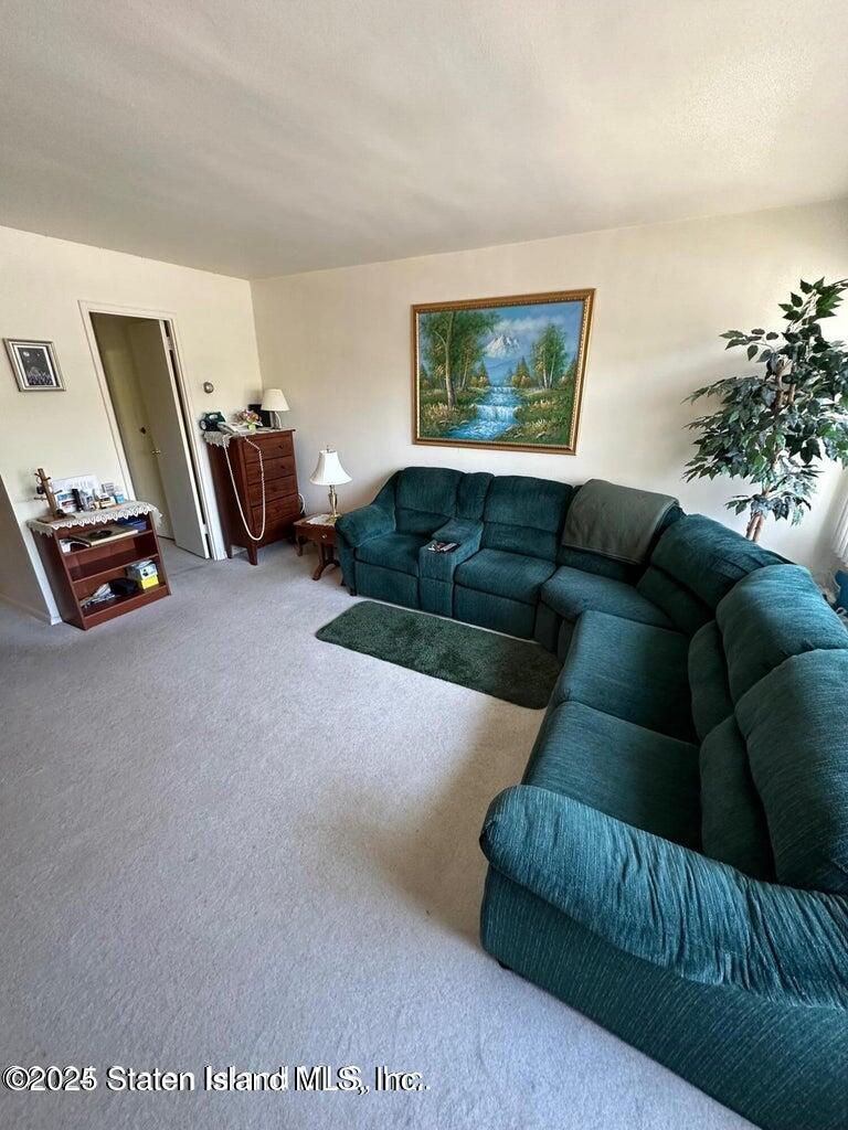 1000 Clove Road, Unit 3F Staten Island, NY 10301 - Photo 12 of 13 a living room with furniture and a flat screen tv