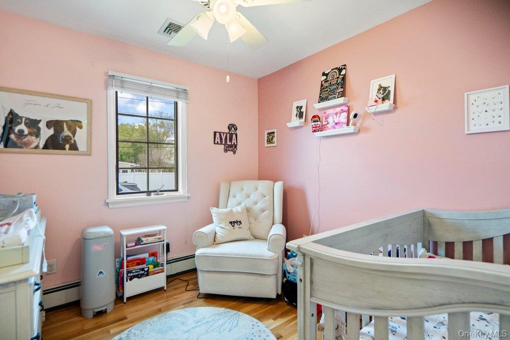 101 Sexton Road West Babylon, NY 11704 - Photo 21 of 33 a living room with furniture and a baby crib