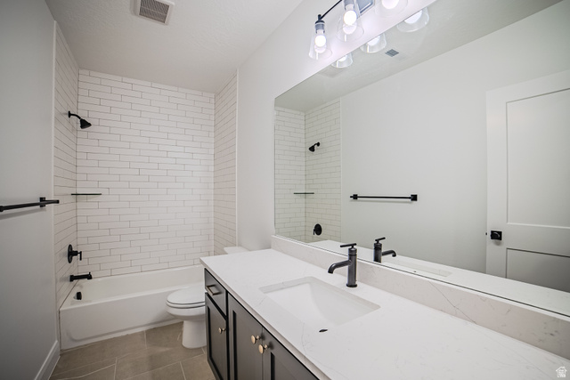 45 North Scarlet Maple Road, Unit 4317 Vineyard, UT 84059 - Photo 32 of 35 Bathroom featuring a white subway tile shower surround, a built-in tub, a vanity with a white countertop and integrated sink, matte black fixtures, and a large wall-mounted mirror