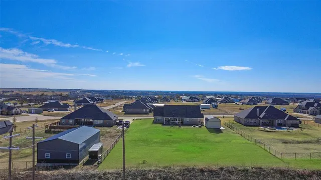 a view of a house with a yard and sitting area