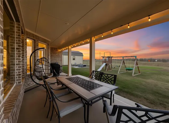 a dining room with furniture and a floor to ceiling window