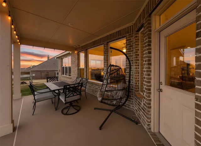 a backyard of a house with table and chairs