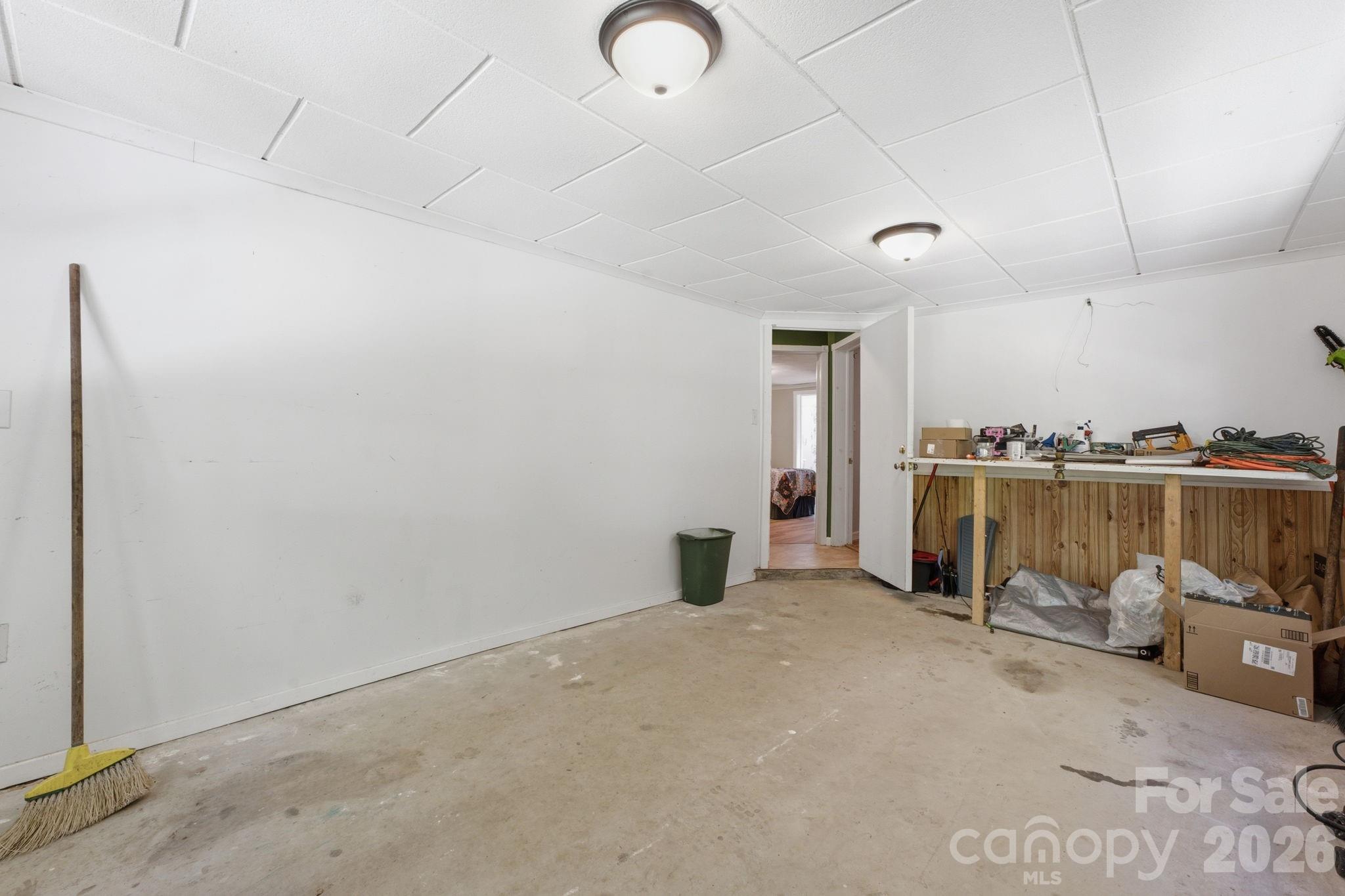 583 Dark Ridge Road Sylva, NC 28779 - Photo 43 of 48 a view of a livingroom with a chair and potted plant on the wall
