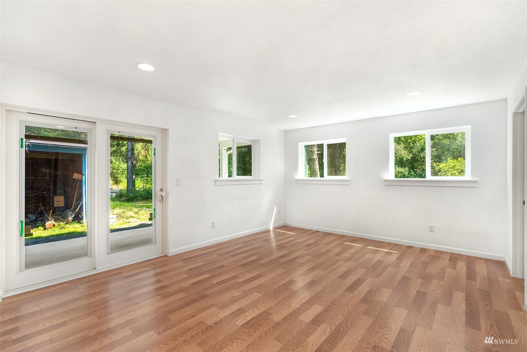 187 Pine Tree Road Toledo, WA 98591 - Photo 9 of 31 an empty room with wooden floor and windows