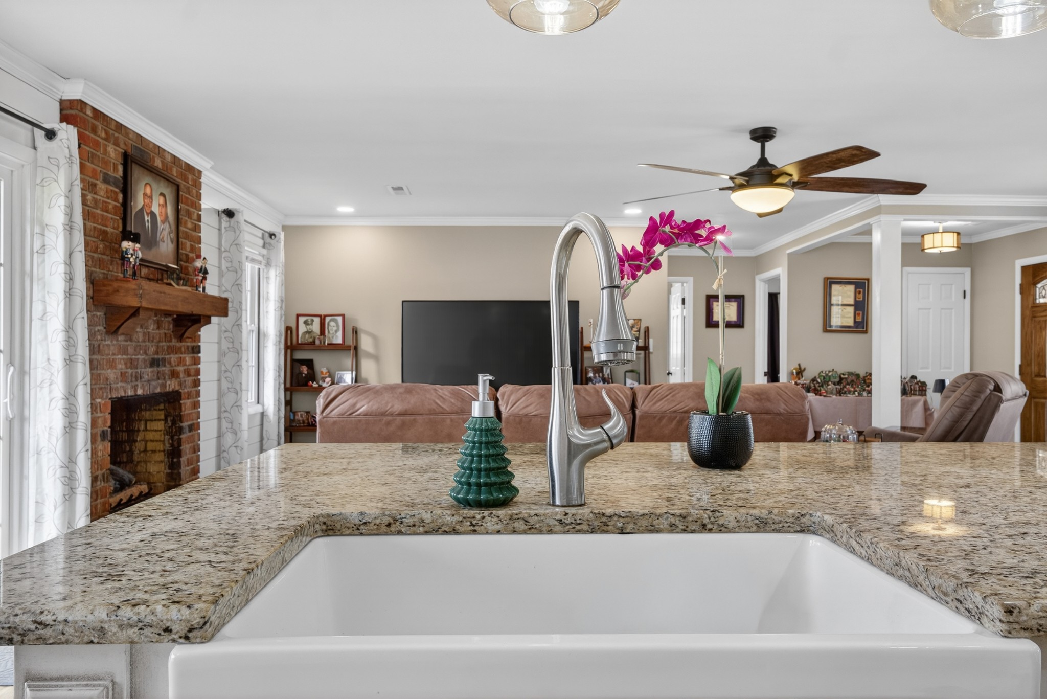 5 Camper Creek Road Fayetteville, TN 37334 - Photo 16 of 51 a kitchen with a faucet a potted plant and a fireplace