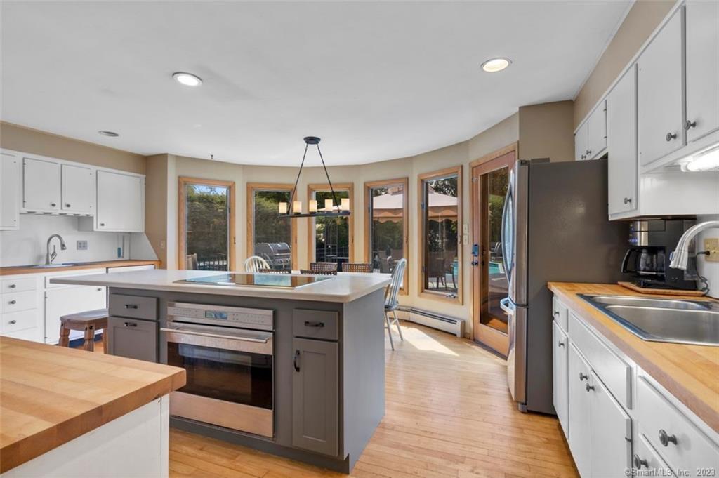 a kitchen with stainless steel appliances granite countertop a stove refrigerator and cabinets