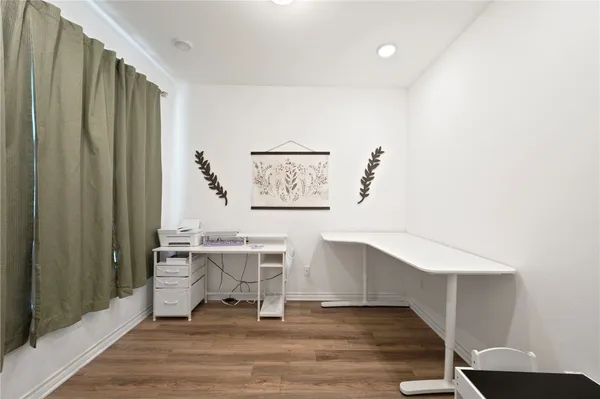 a view of a workspace with furniture and a window