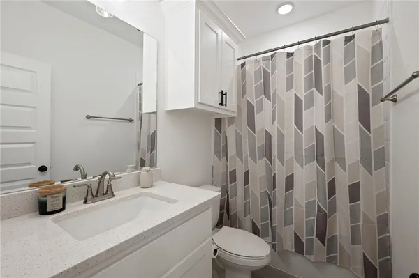 a bathroom with a sink toilet and shower